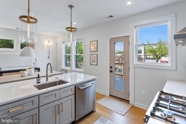 a view of a kitchen with a sink and refrigerator