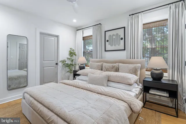 a bedroom with furniture and a flat screen tv