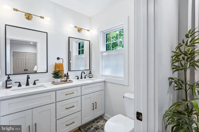 a bathroom with double sink and a mirror