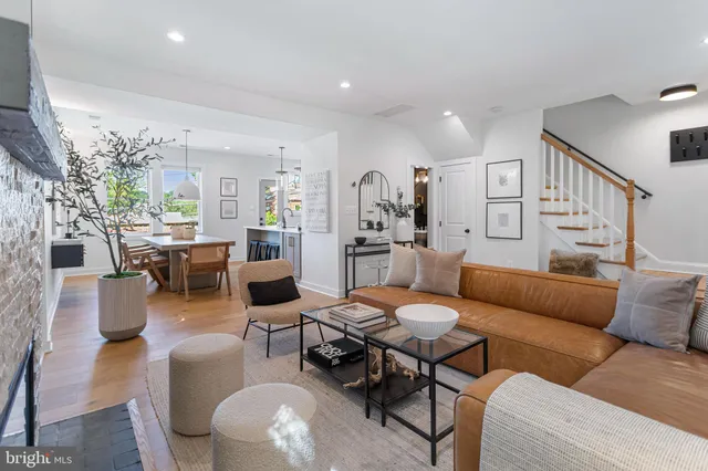 a living room with furniture kitchen view and a table