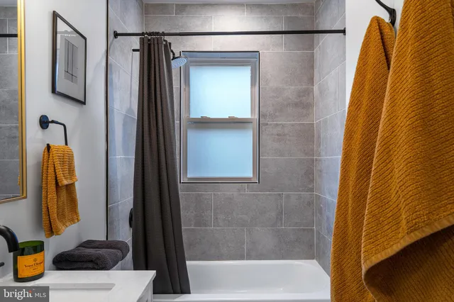 a bedroom with bed and a large window