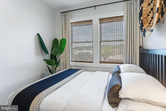 a bedroom with bed and wooden floor