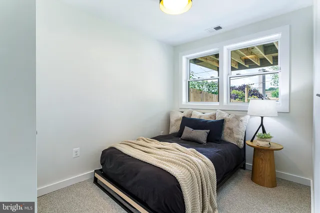 a view of a patio with table and chairs with wooden floor and fence