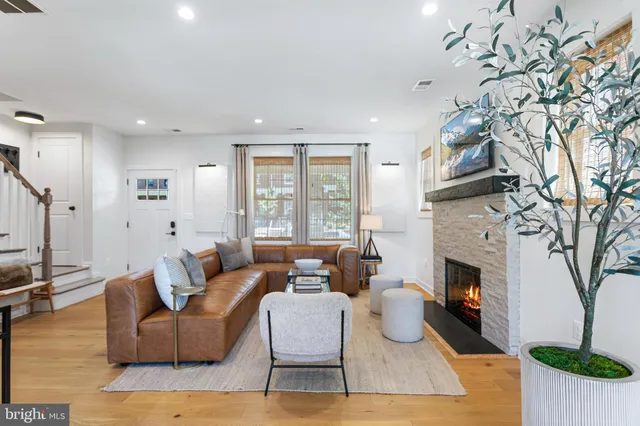 a living room with furniture large window and a fireplace