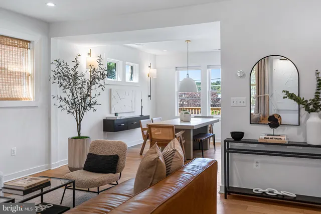 a living room with furniture a chandelier and a window