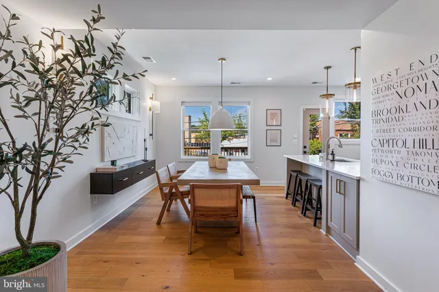 a dining room with furniture and wooden floor