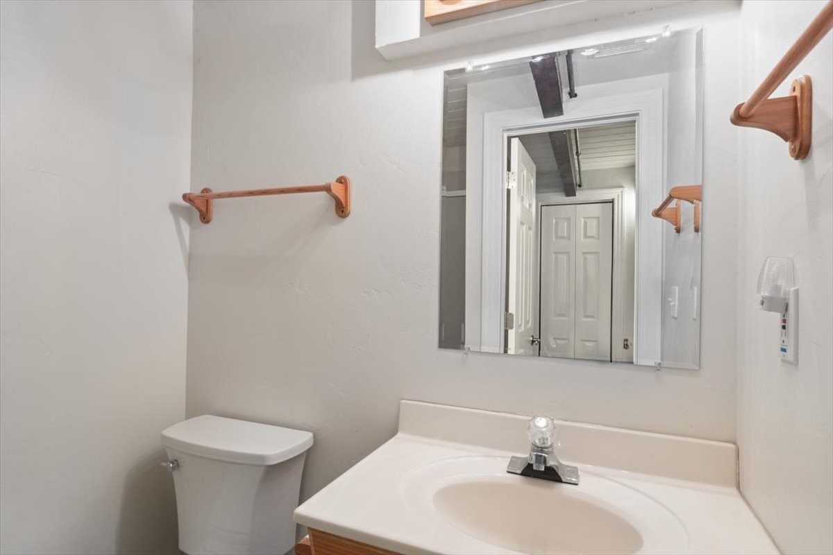 304 South High Street, Unit 3S Breckenridge, CO 80424 - Photo 14 of 20 a bathroom with a sink a toilet and mirror