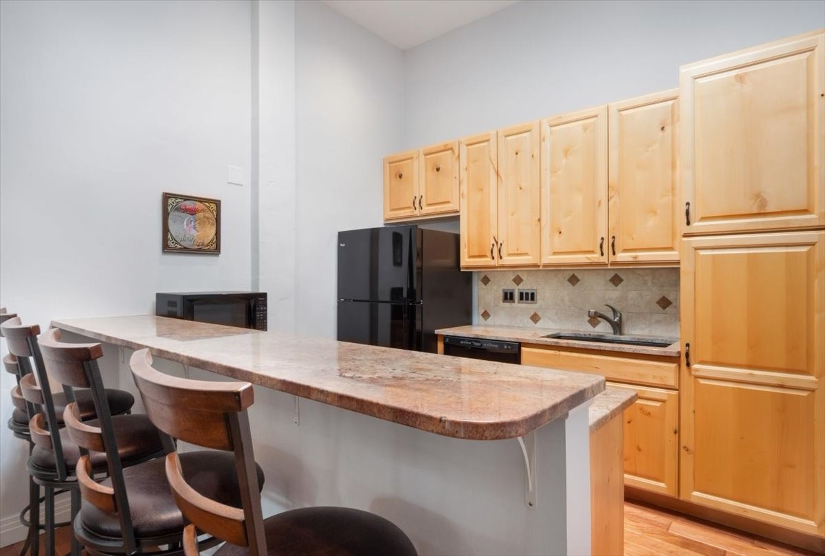 304 South High Street, Unit 3S Breckenridge, CO 80424 - Photo 4 of 20 a kitchen with stainless steel appliances a refrigerator and a stove top oven