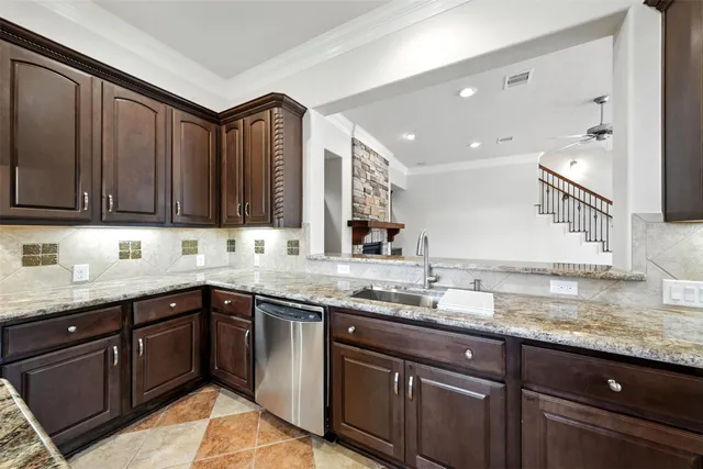 a kitchen with granite countertop a sink and cabinets