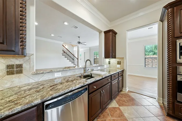 a kitchen with granite countertop a sink and a stove