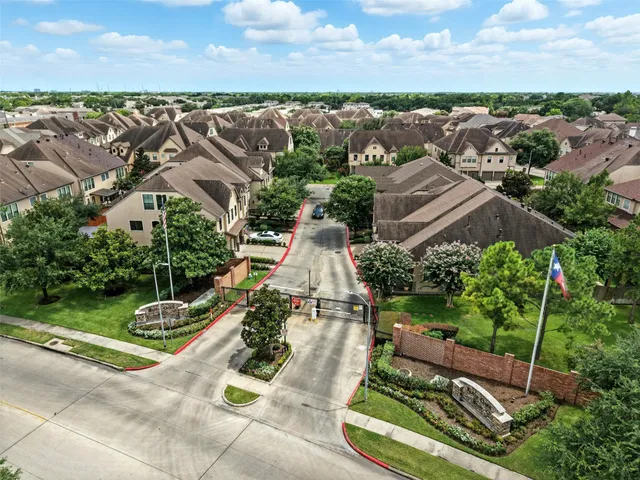 an aerial view of a house with garden space and street view