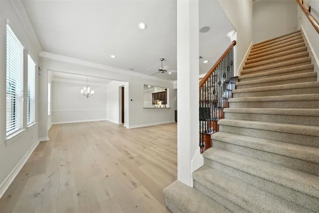 wooden floor in an empty room with stairs