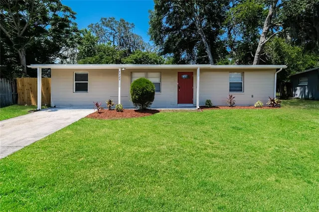 front view of a house with a yard and trees