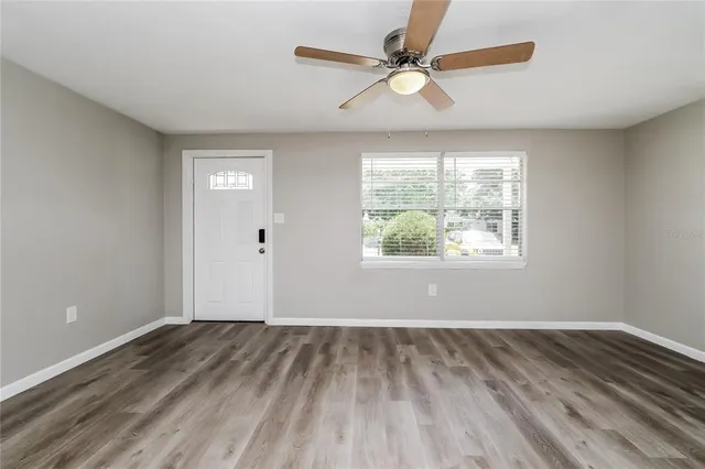 wooden floor in an empty room with a window