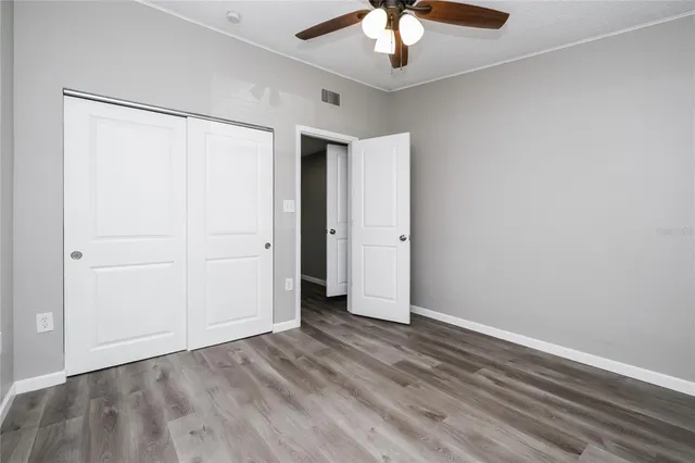 an empty room with a empty space and a ceiling fan