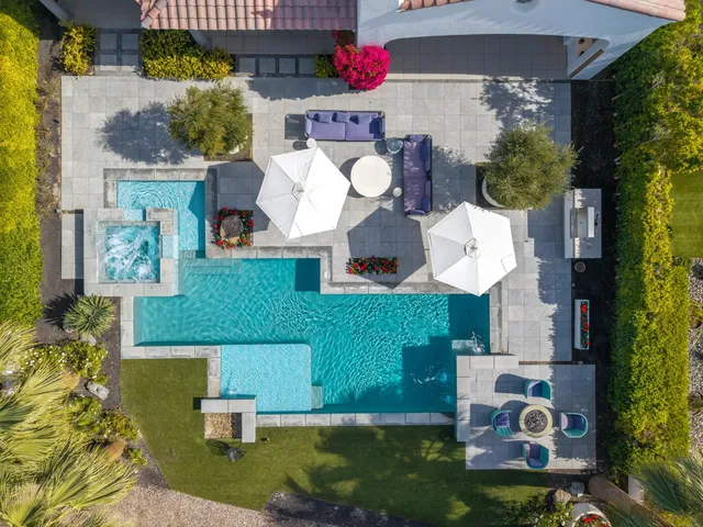 a kitchen with stainless steel appliances a table chairs and a refrigerator