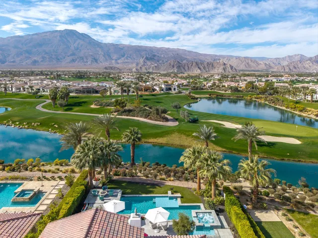 a kitchen with stainless steel appliances a stove a table and chairs