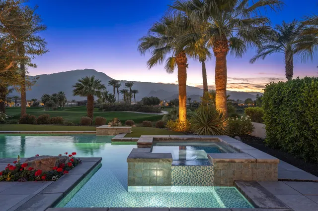 a view of a patio with swimming pool and a chairs