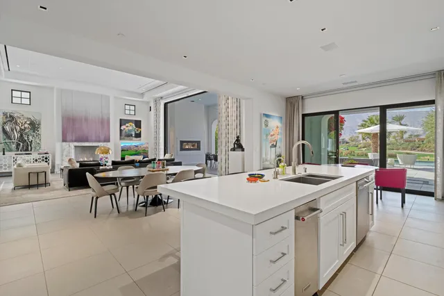 a kitchen with stainless steel appliances granite countertop a sink and a refrigerator