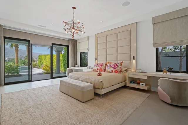 a view of a patio with table and chairs potted plants and a large tree