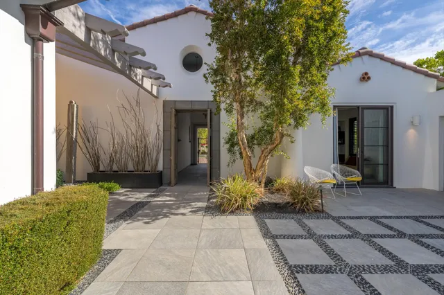 an aerial view of residential houses with outdoor space and trees