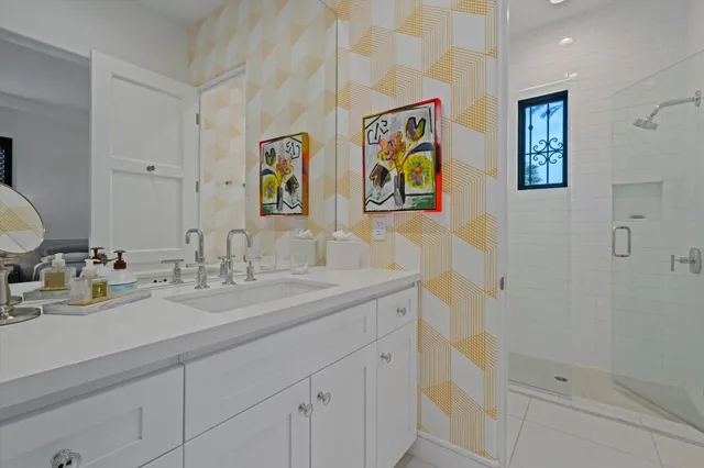 a view of a lake with couches and table and chairs under an umbrella