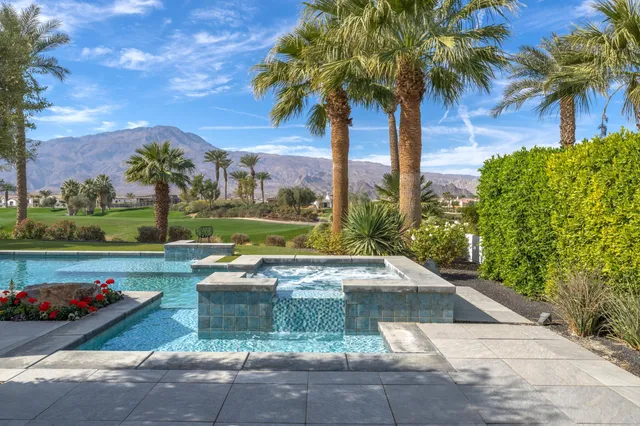 a living room with furniture fireplace and a large window