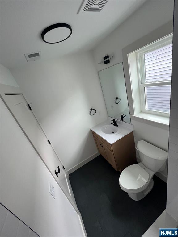 1060 Magnolia Avenue Elizabeth, NJ 07201 - Photo 20 of 22 a bathroom with a toilet a sink and mirror