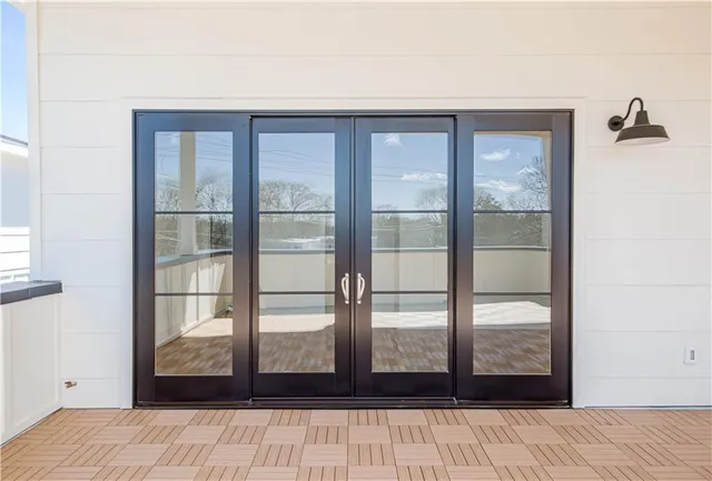 a living room with a table and windows