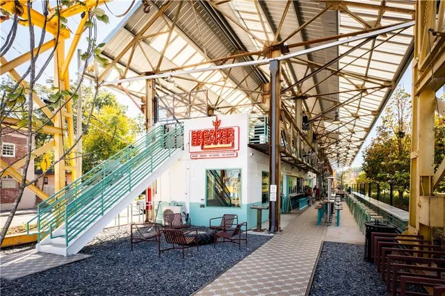 a view of a chair and tables in the patio