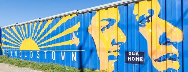a view of a street with potted plants