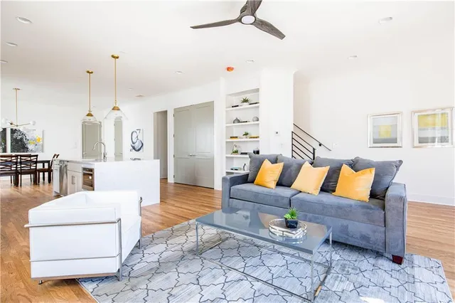 a living room with furniture and a chandelier