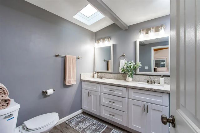 a bathroom with a toilet sink and mirror