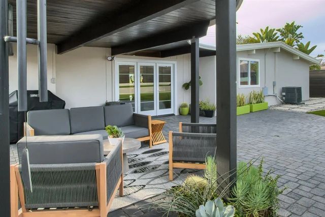 a view of a house with a porch and furniture