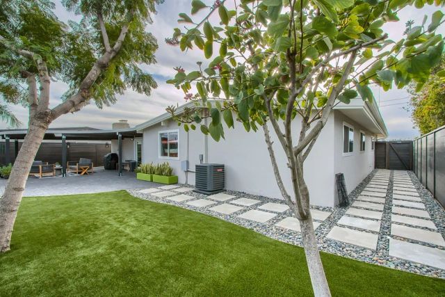 a view of a house with backyard porch and sitting area