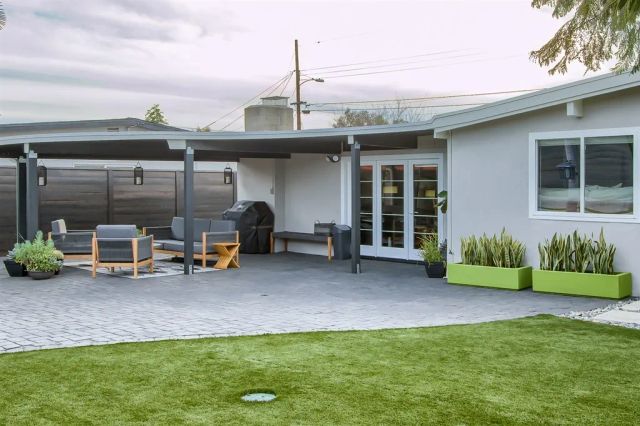a view of a house with a patio and a garden