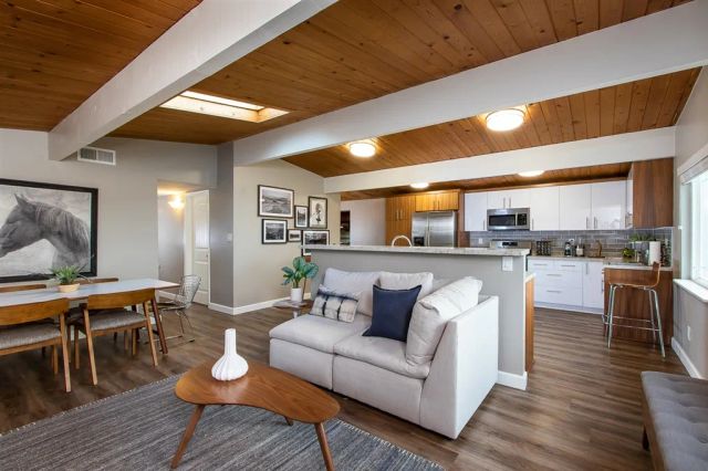 a living room with furniture and kitchen view