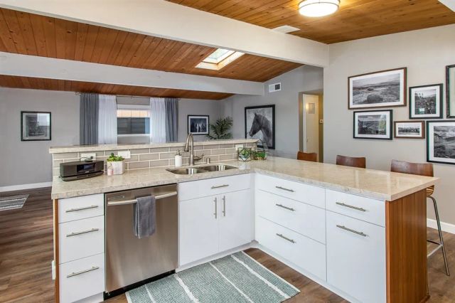 a spacious bathroom with a sink and a mirror