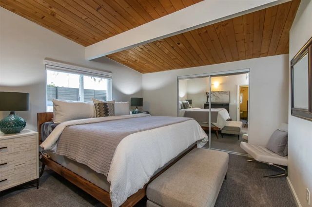 a bedroom with a bed couch and window