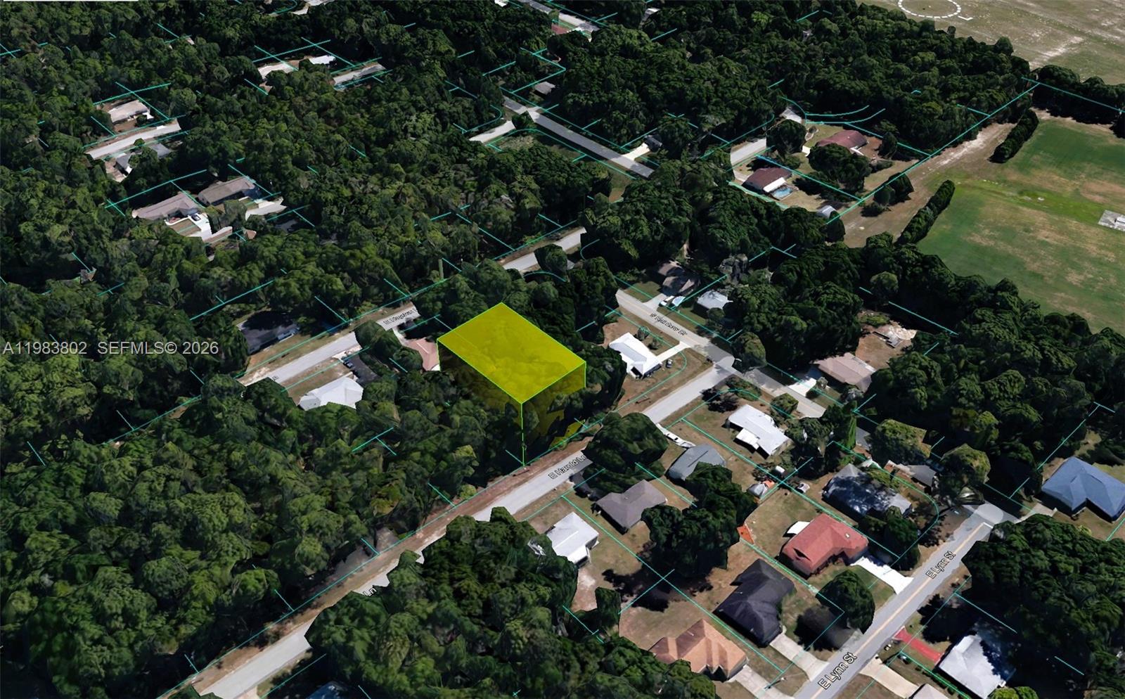 an aerial view of a house with a yard and outdoor seating