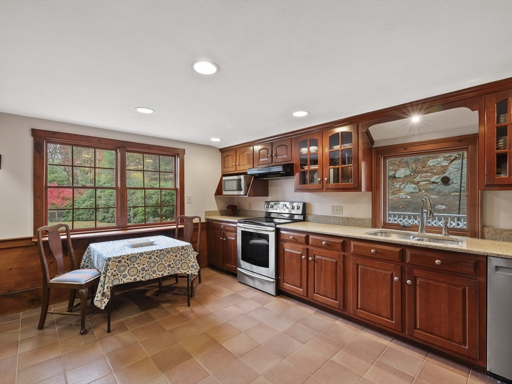 38 Mohawk Drive Acton, MA 01720 - Photo 14 of 35 a large kitchen with stainless steel appliances granite countertop a stove and a sink
