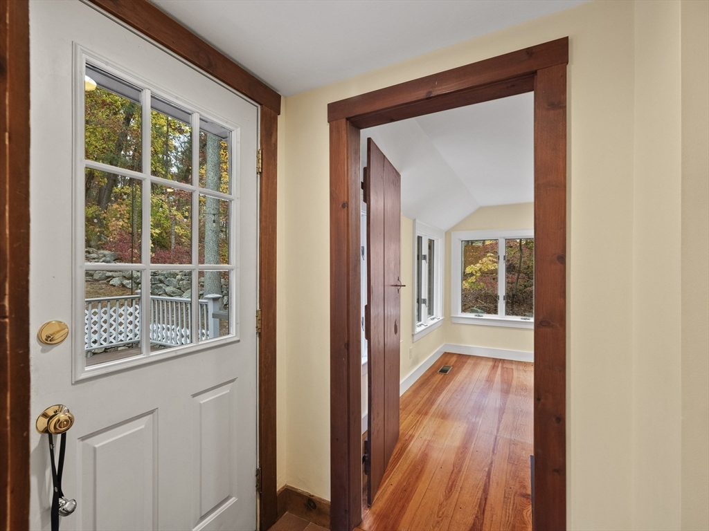 38 Mohawk Drive Acton, MA 01720 - Photo 16 of 35 a view of a hallway with wooden floor and a window