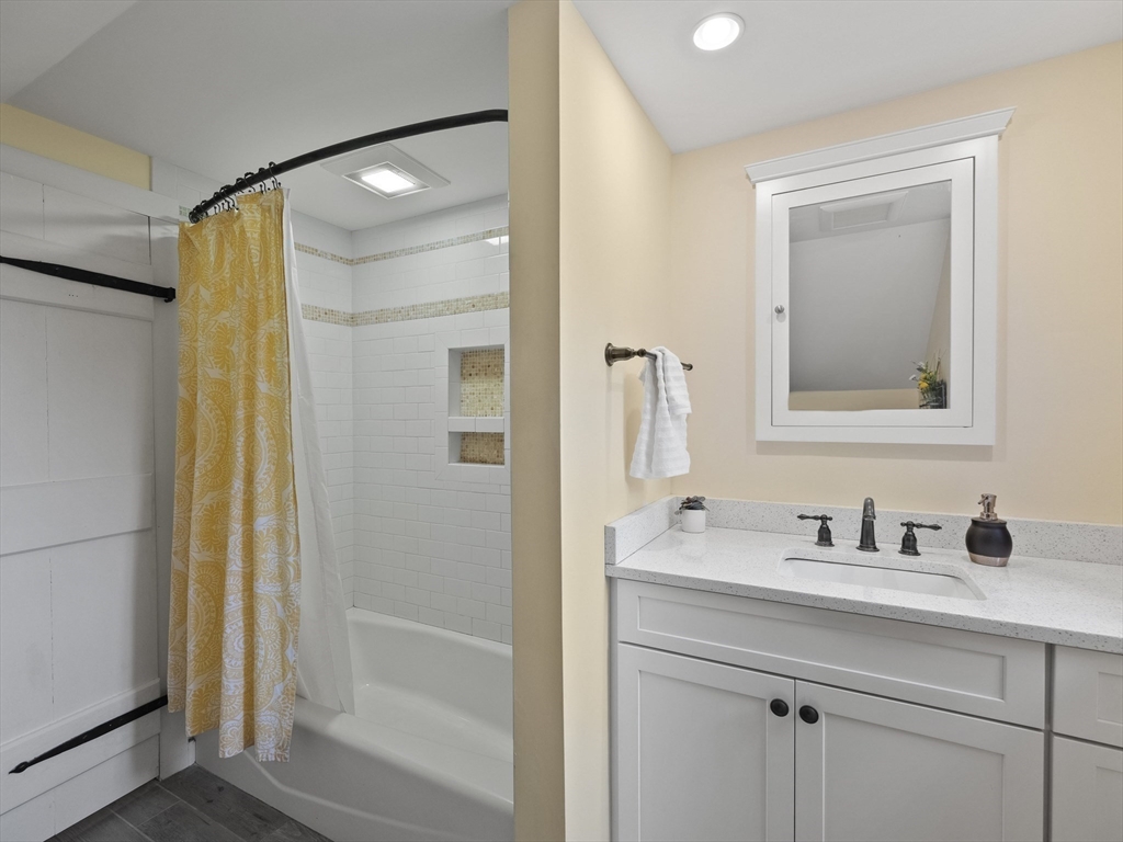38 Mohawk Drive Acton, MA 01720 - Photo 22 of 35 a bathroom with a shower sink and mirror