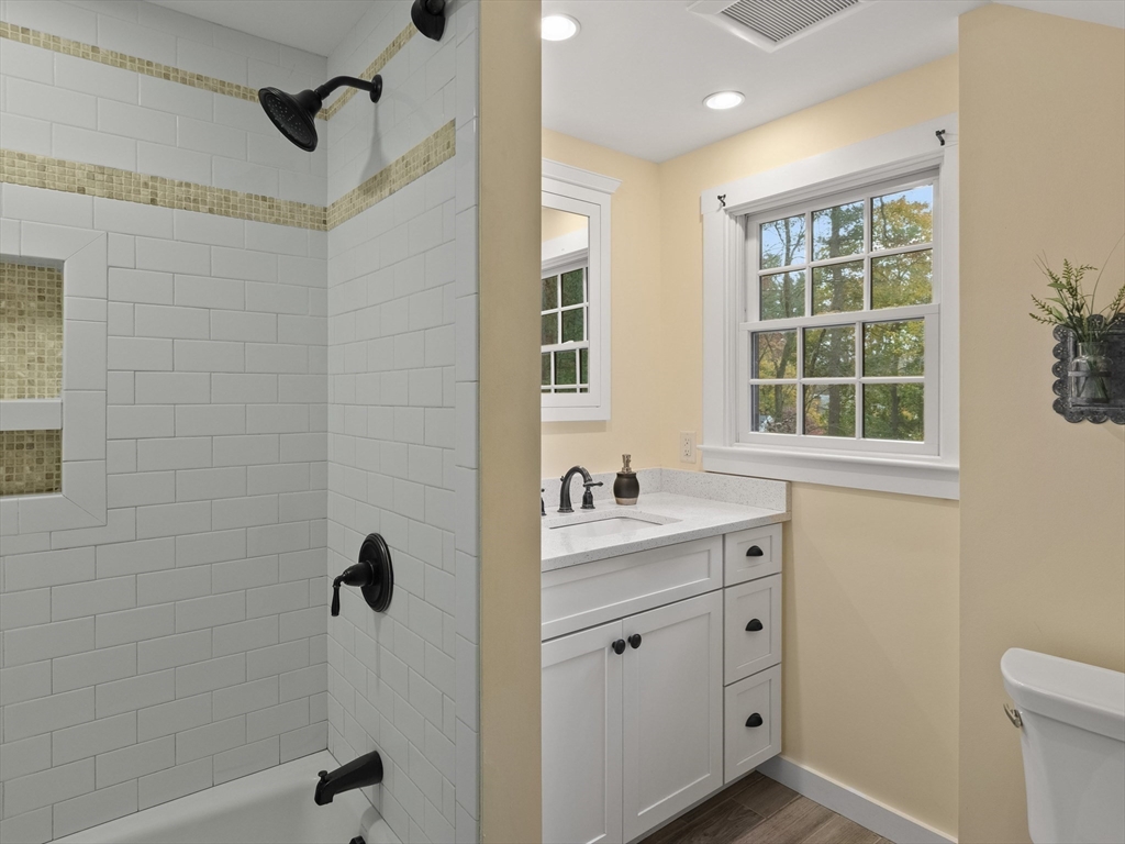 38 Mohawk Drive Acton, MA 01720 - Photo 24 of 35 a bathroom with a granite countertop sink a mirror and a shower