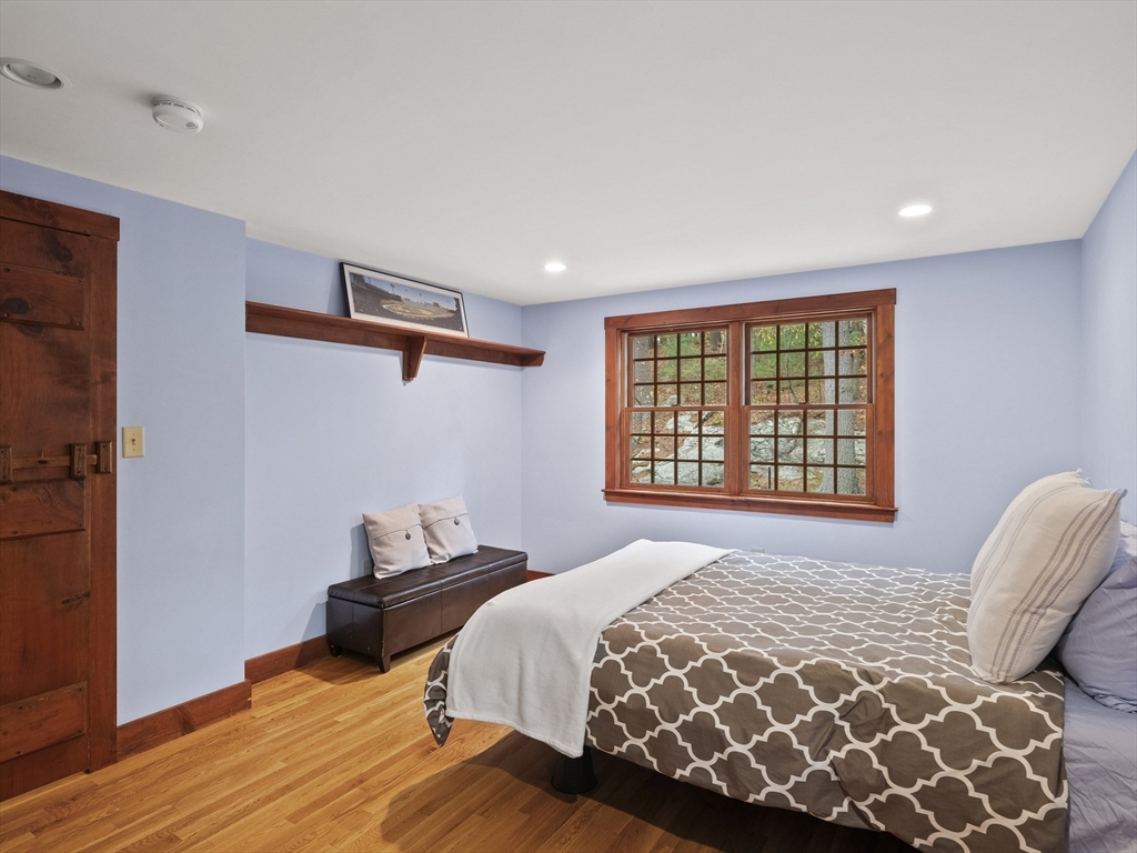 38 Mohawk Drive Acton, MA 01720 - Photo 25 of 35 a bedroom with a bed and wooden floor