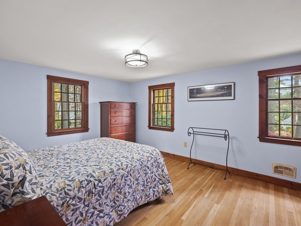 38 Mohawk Drive Acton, MA 01720 - Photo 28 of 35 a bedroom with a bed and wooden floor
