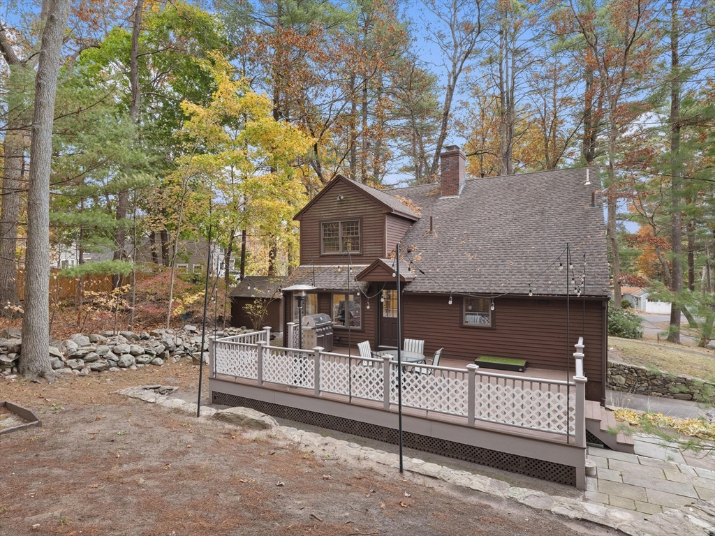 38 Mohawk Drive Acton, MA 01720 - Photo 32 of 35 a view of a house with a wooden fence and a bench