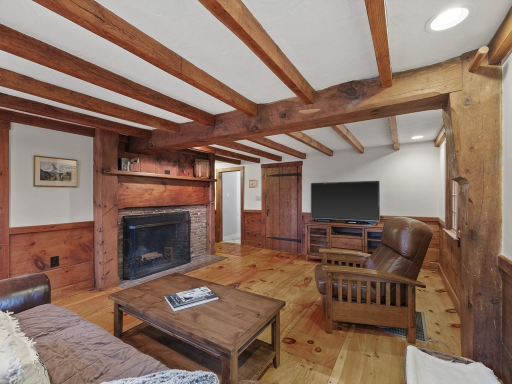 38 Mohawk Drive Acton, MA 01720 - Photo 4 of 35 a living room with furniture a flat screen tv and a fireplace