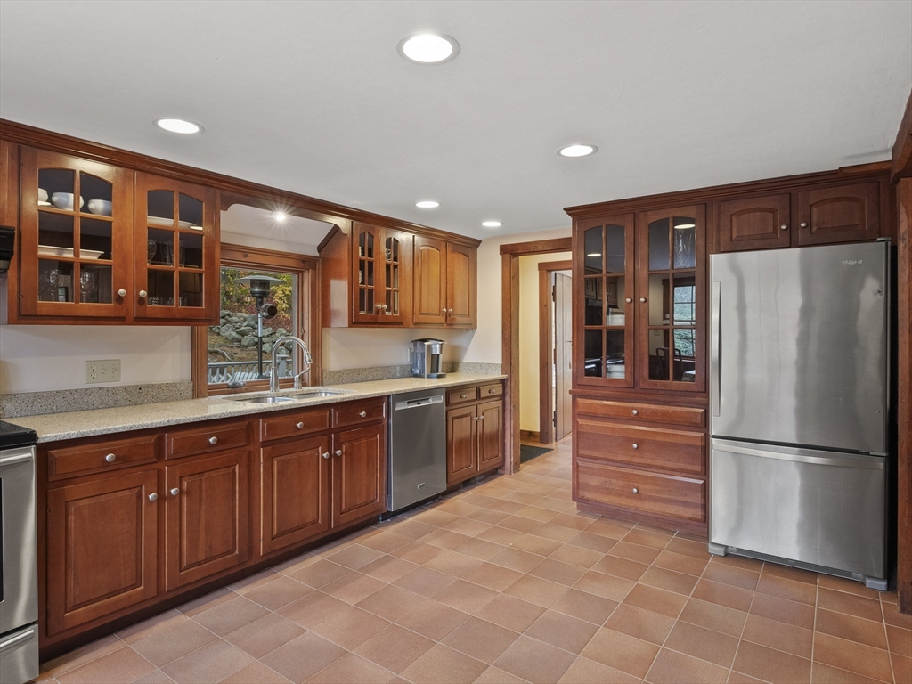 38 Mohawk Drive Acton, MA 01720 - Photo 10 of 35 a large kitchen with stainless steel appliances granite countertop a refrigerator and a sink