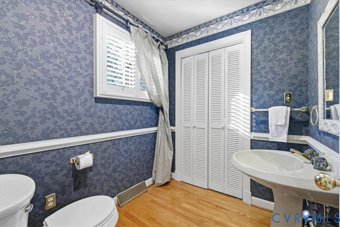503 Prince George Avenue Hopewell, VA 23860 - Photo 13 of 25 a bathroom with a sink a toilet a mirror and shower